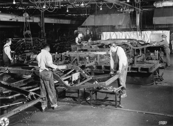 WHi 4153: Workers at the A.O. Smith Corporation in Milwaukee assemble frames for Cadillac automobiles in 1954.]