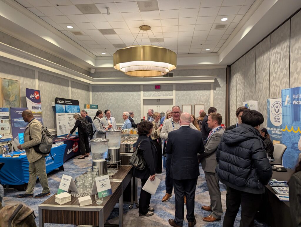 People gather around exhibit tables.