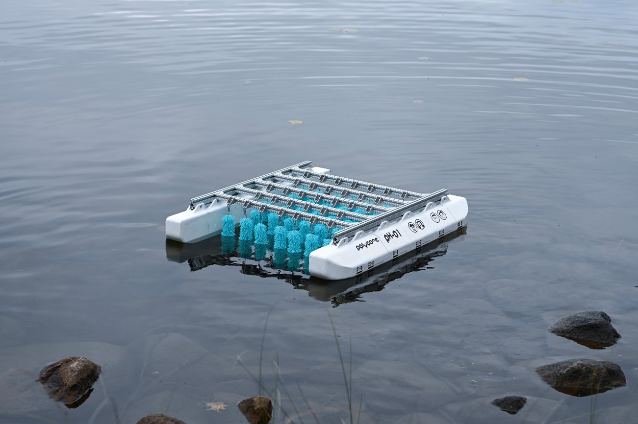 Floating system of metal bars across two white buoys with blue cylinders underneath.