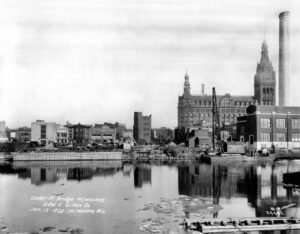 black and white photos of city buildings behind a river that is full of debris