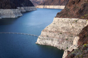 Lake surrounded by bluffs. The lower part of the bluffs are lighter than the rest, indicating where the water used to rise.