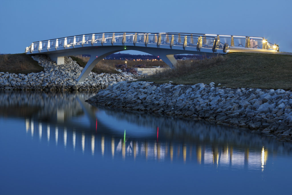 White bridge over an outlet leading to Lake Michigan at dusk